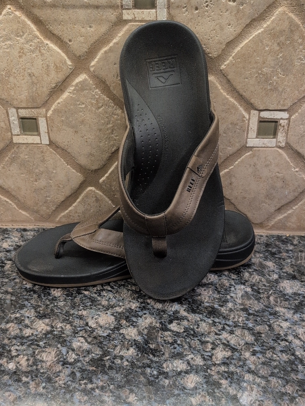 Reef Men’s Black Footbed with Brown Leather Strap Flip Flops